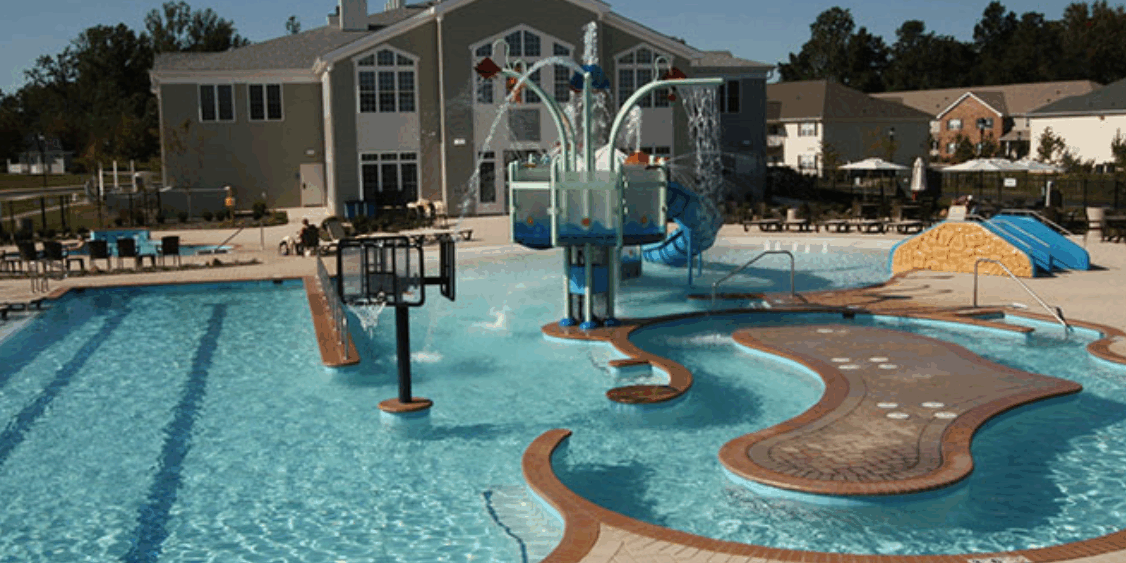 A pool with water slides and a slide.