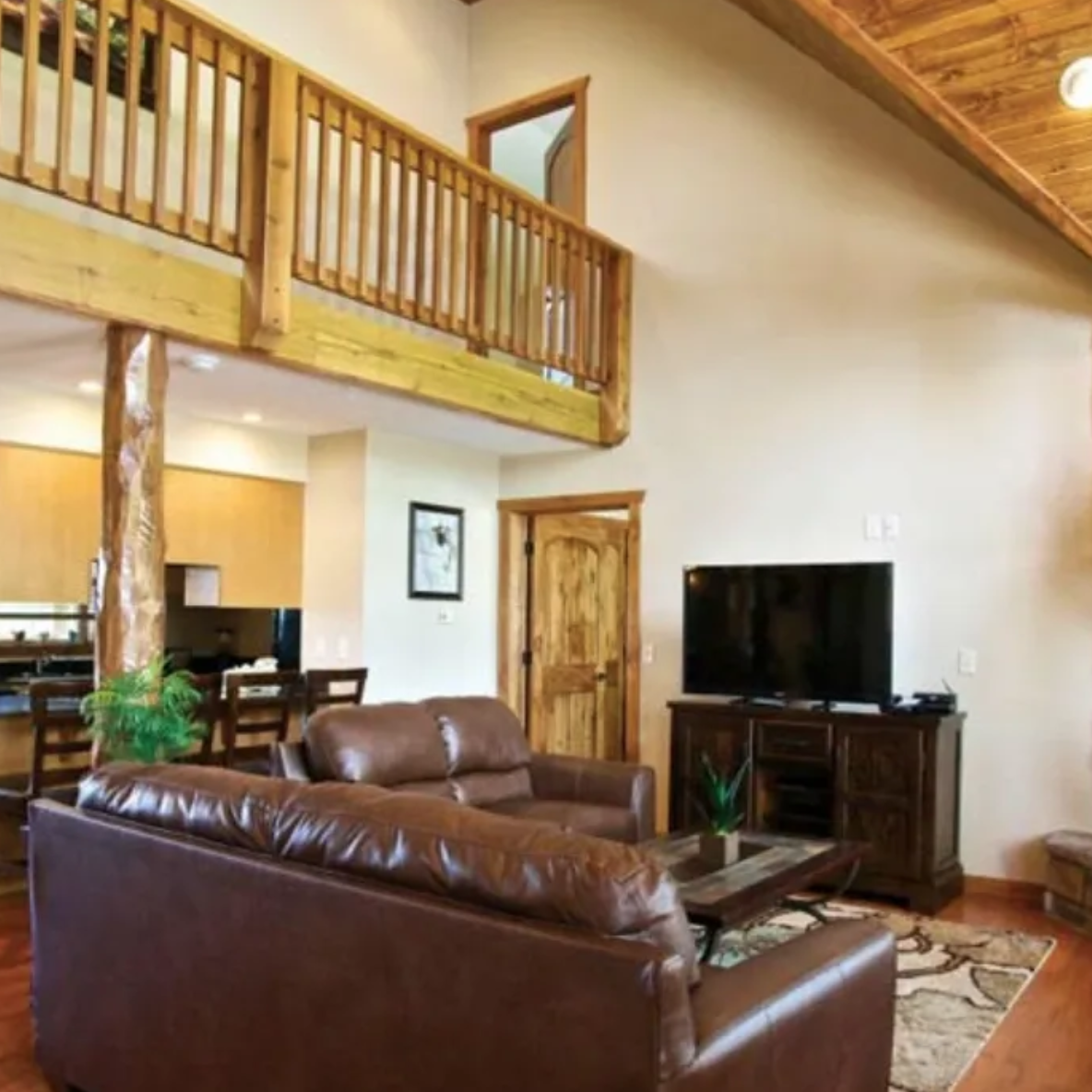 A living room with leather furniture and a large tv.